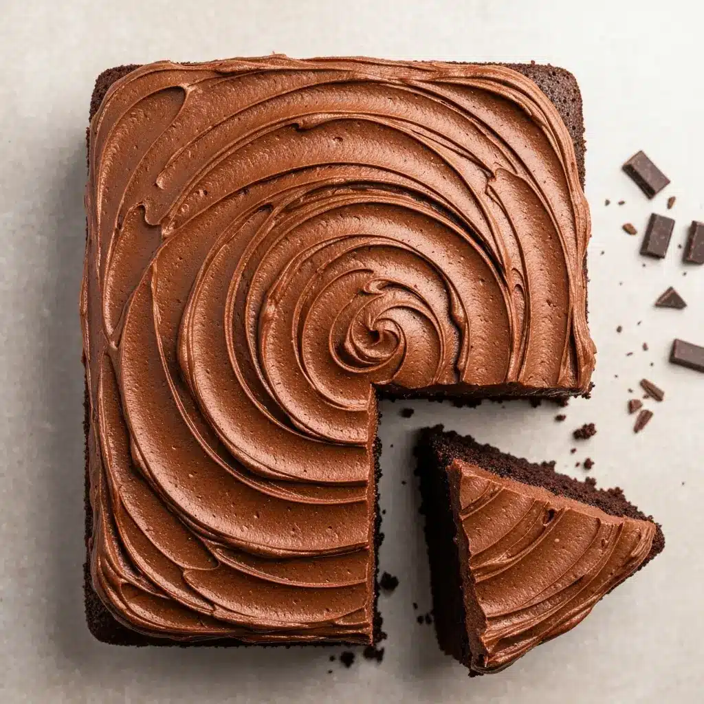 Overhead view of a 9x13 easy chocolate cake with one slice removed.