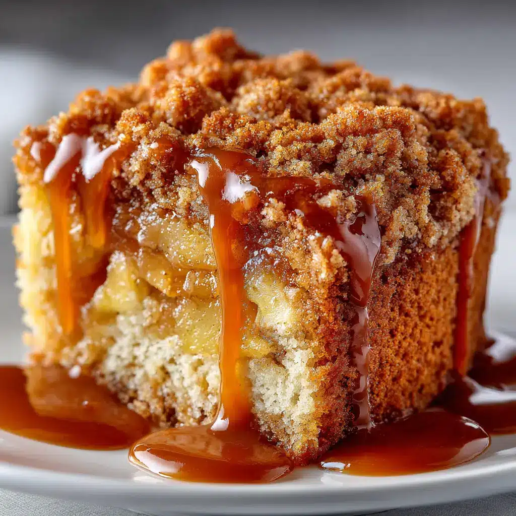 The apple crumb cake batter spread in a baking pan, with the thick, buttery crumb topping generously sprinkled over the top before baking.