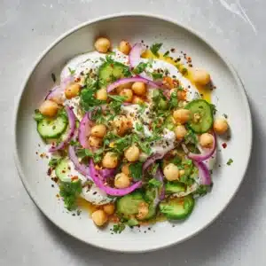 A close-up shot of the high-protein chickpea salad, showing the creamy texture of the cottage cheese and the fresh crunch of celery and red onion.
