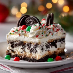 A close-up shot of a perfect slice of the holiday Oreo dessert on a white plate, highlighting the clean, delicious layers.