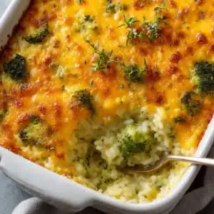 An extreme close-up shot of the cheesy broccoli rice casserole, showing the creamy texture and tender broccoli florets.