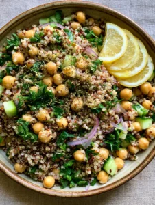 Top-down view of a colorful Lemon Herb Quinoa with Chickpeas salad featuring red and white quinoa and fresh herbs.